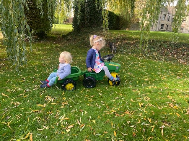 Cara riding a toy tractor