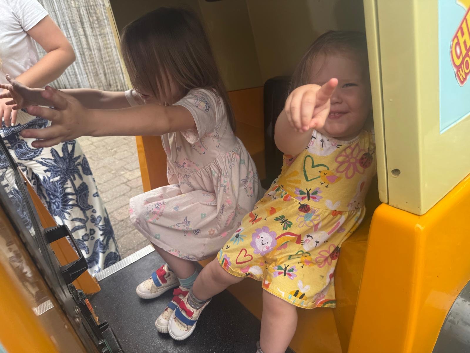 Cara and Eliza playing in a truck ride