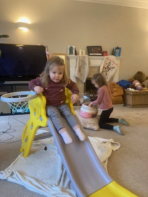 Eliza riding a toy tractor